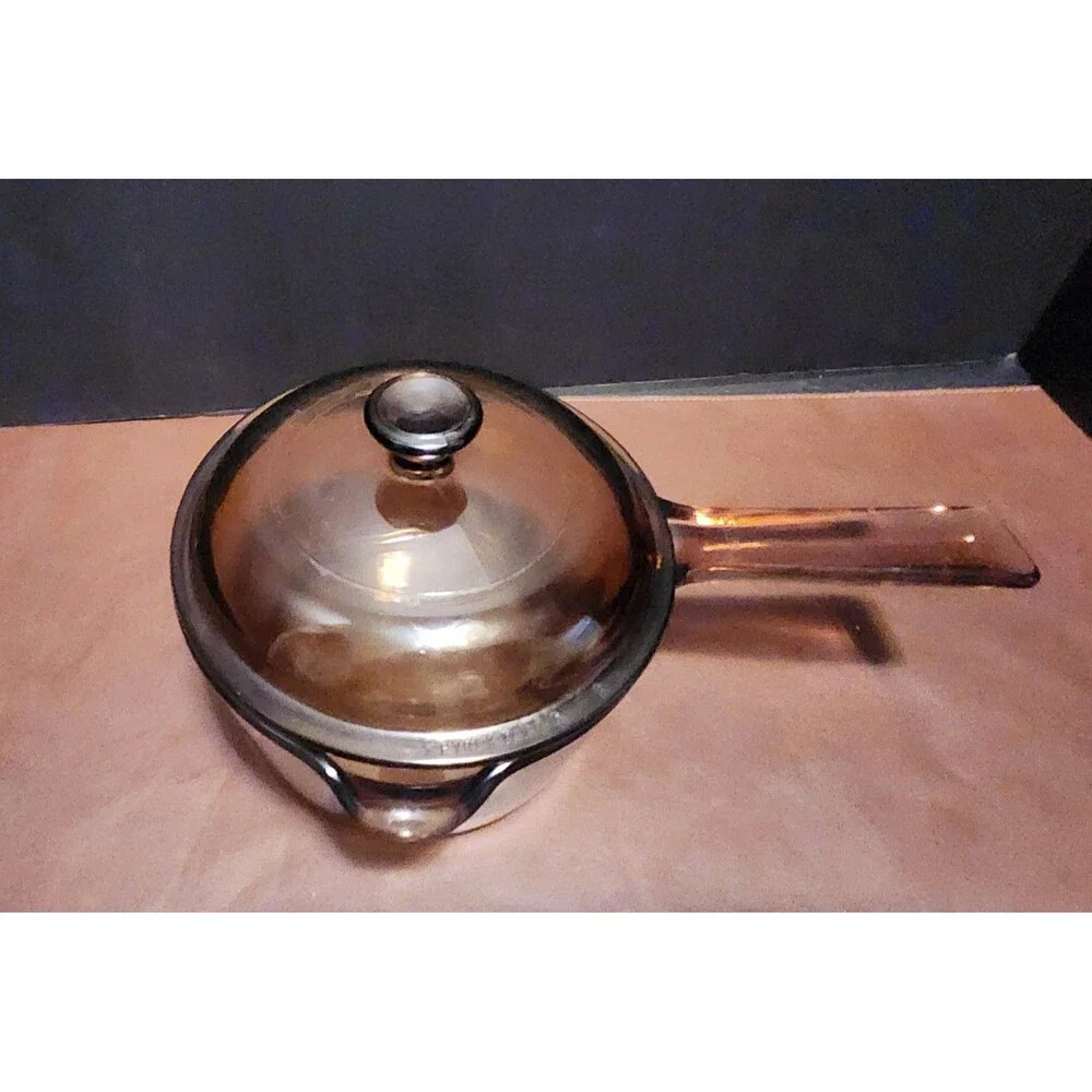 This item appears to be a vintage Corning Visions amber glass 1-liter...